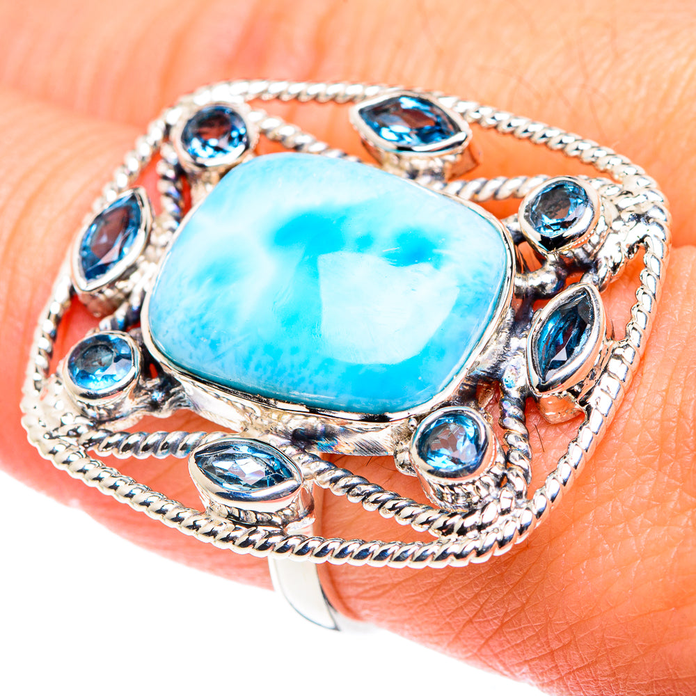 Sterling silver ring with large oval turquoise cabochon and blue oval stone border