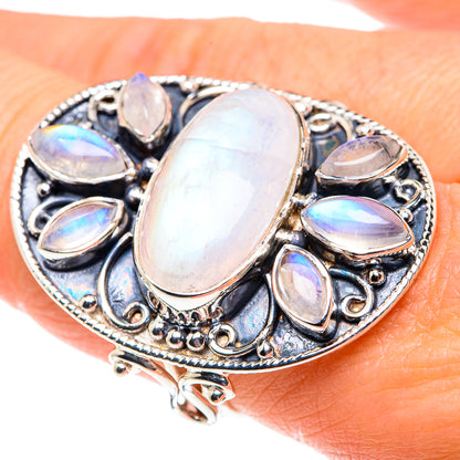 Ornate sterling silver ring with large oval rainbow moonstone and side teardrop stones