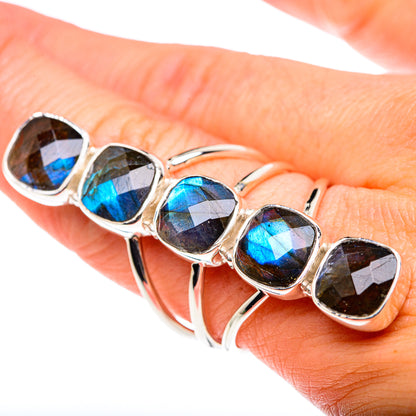 Silver sterling ring on hand with five blue-and-gold oval labradorite bezels