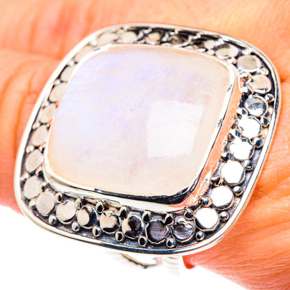 Sterling silver ring with oval opalescent moonstone and scalloped halo detail