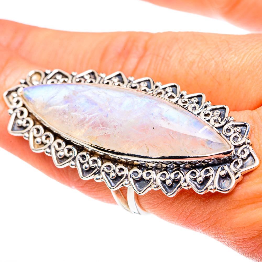 Opalescent moonstone marquise sterling silver ring on hand, detailed filigree setting