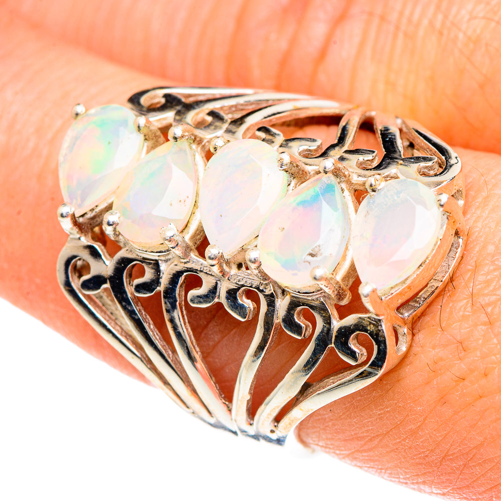 Large oval opal ring with faceted white opals and ornate gold-tone filigree setting
