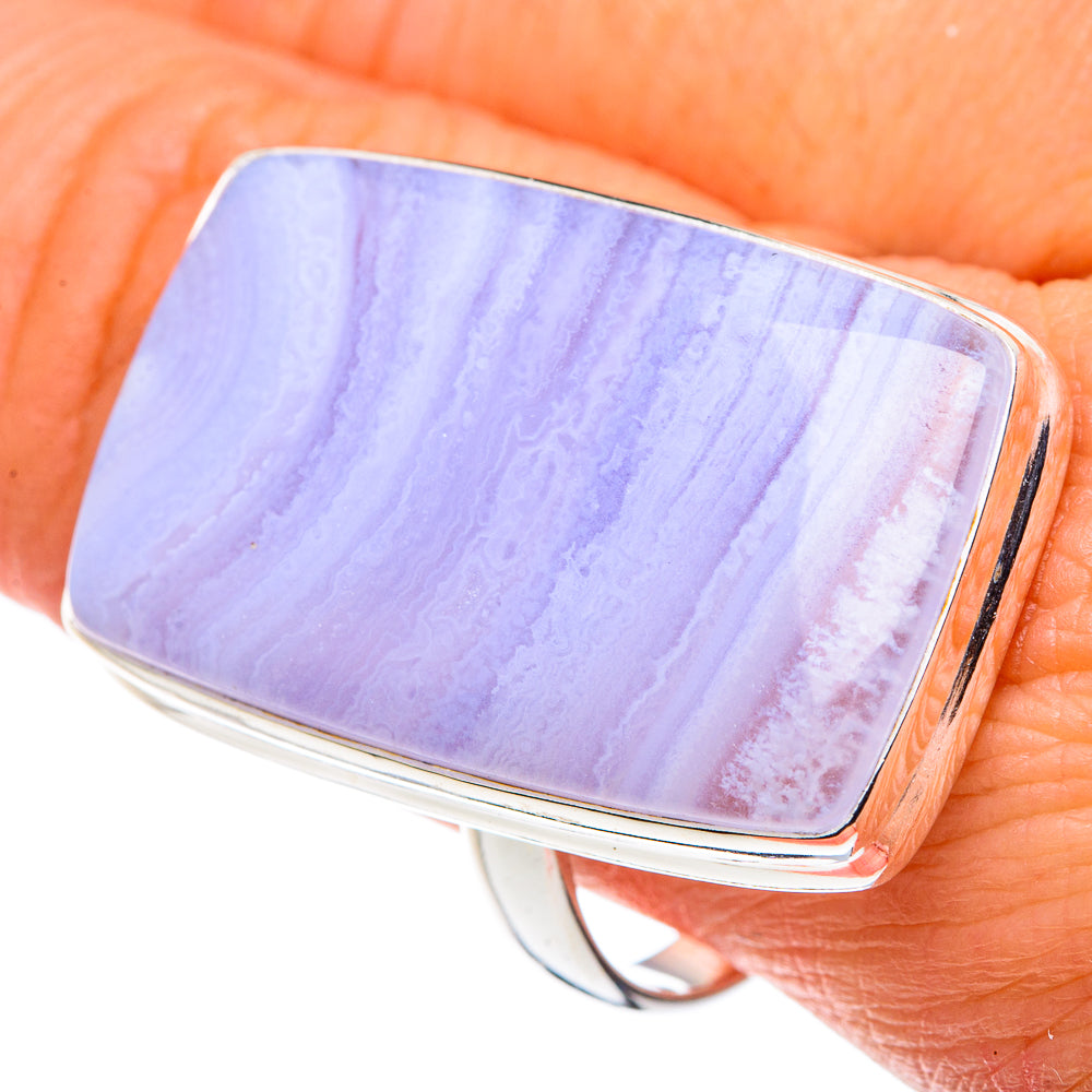 Blue lace agate ring on finger, silver bezel with striped pastel patterns