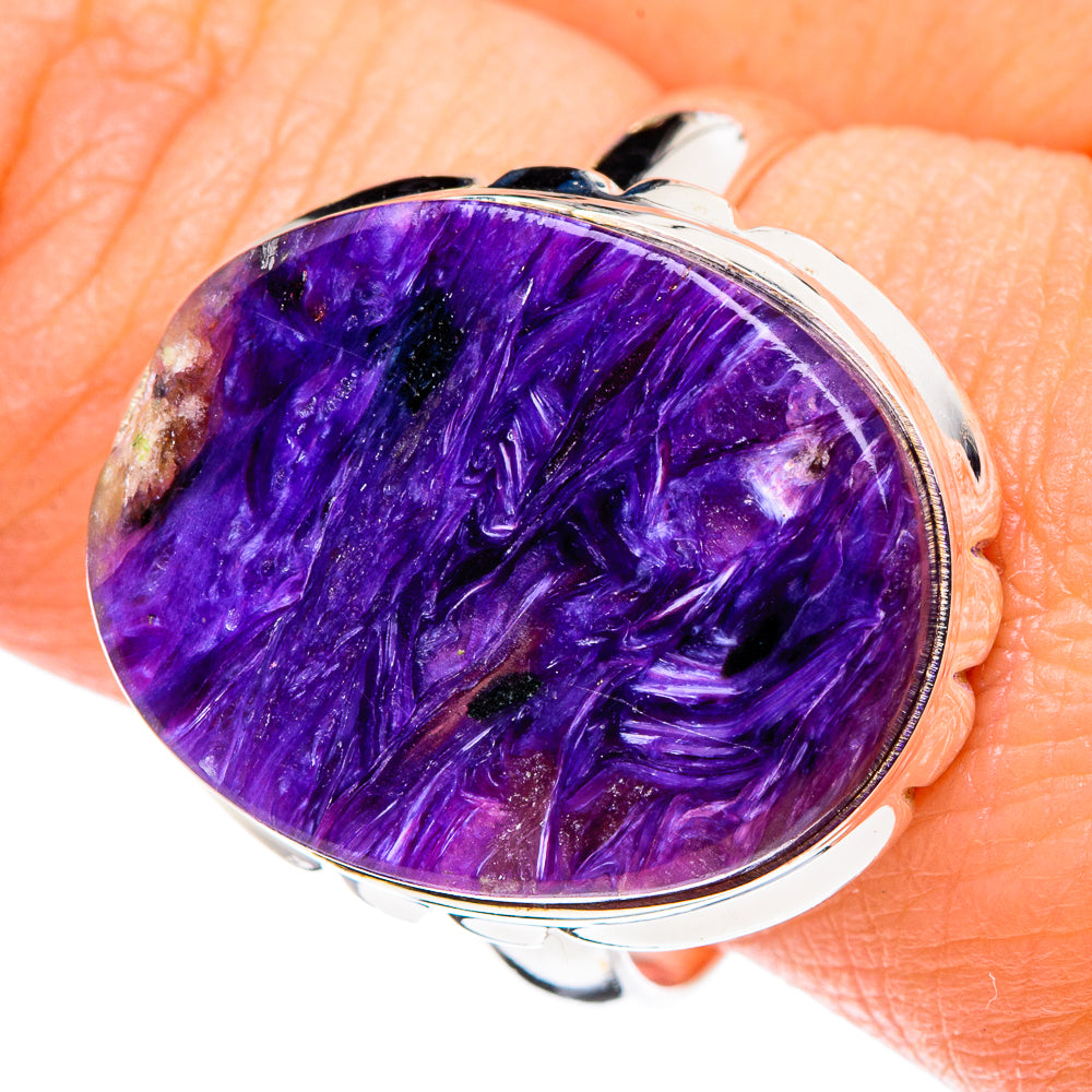 Oval purple charoite cabochon ring on finger, 925 sterling silver bezel, size 11