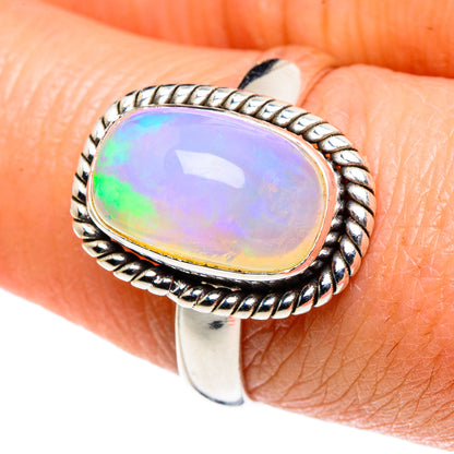 Oval Ethiopian opal cabochon sterling silver ring with rope-style border