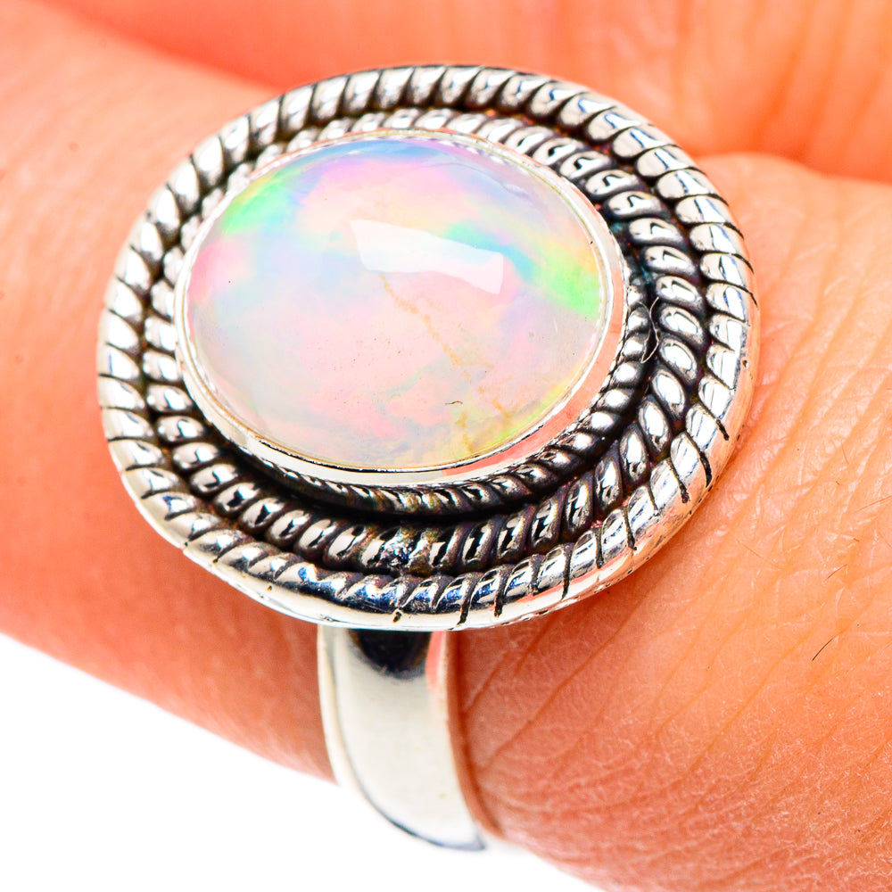 Oval natural opal ring in 925 sterling silver, iridescent bezel setting, close-up