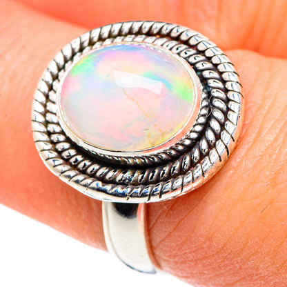 Oval natural opal ring in 925 sterling silver, iridescent bezel setting, close-up