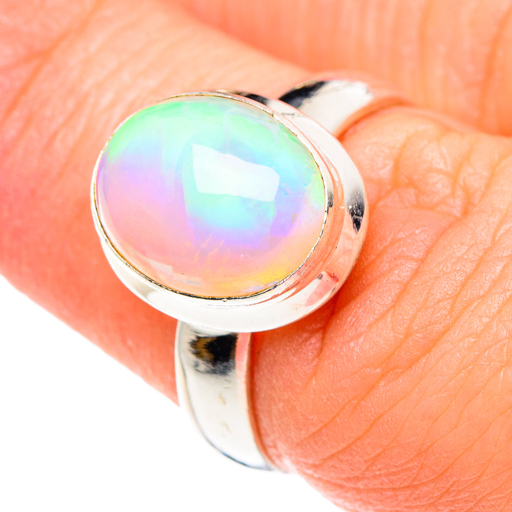 Round opal cabochon ring with rainbow iridescence, silver bezel and band