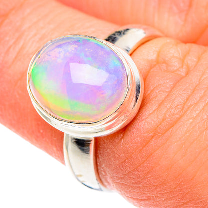 Sterling silver opal ring close-up with rainbow round cabochon bezel setting