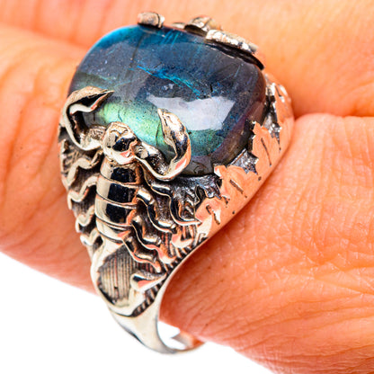 Ornate silver skull ring with large iridescent blue-green oval labradorite gemstone