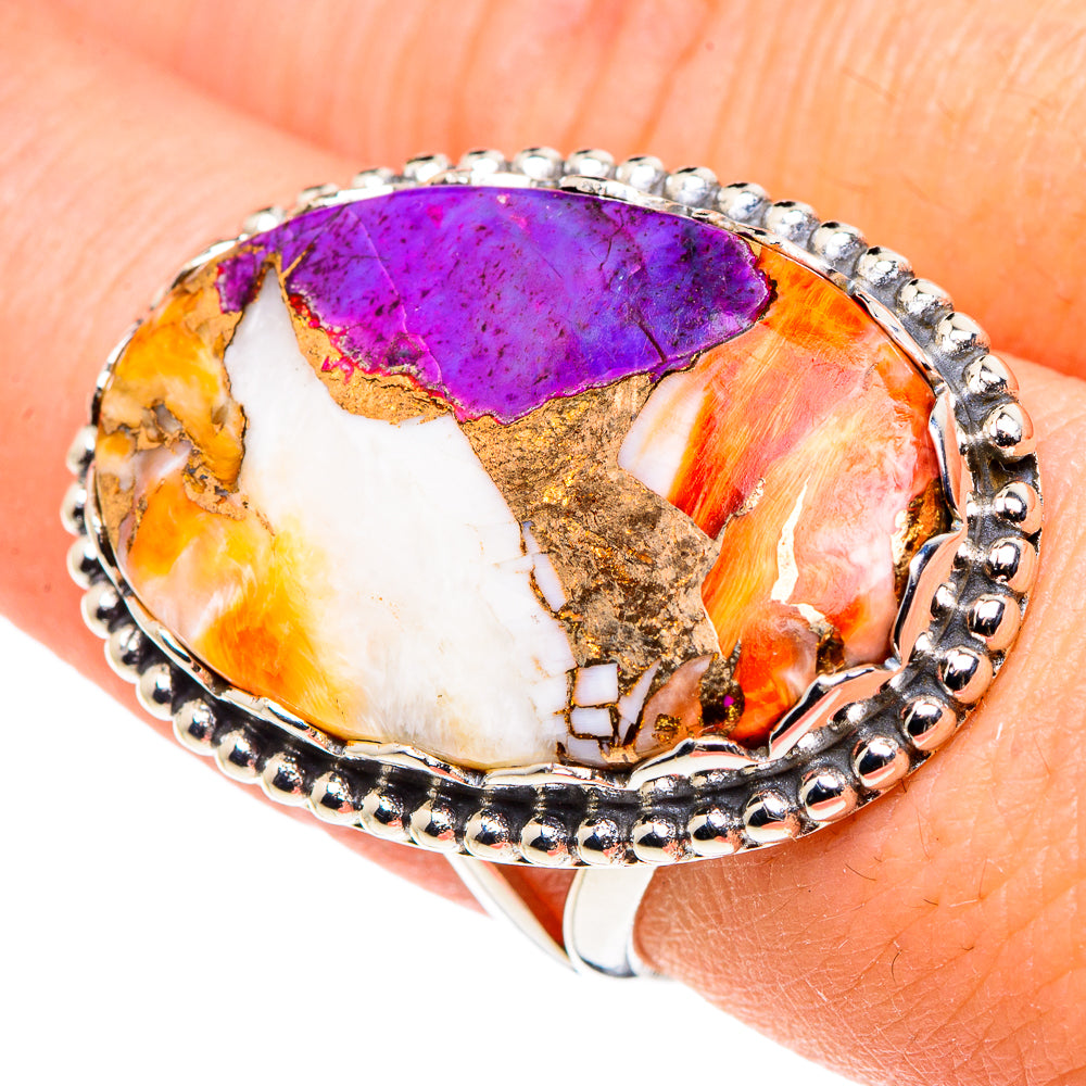 Oval composite stone ring with purple and orange center, white side inlays, silver bezel