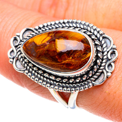 Sterling silver ring with oval amber pietersite, rope border and scalloped side details