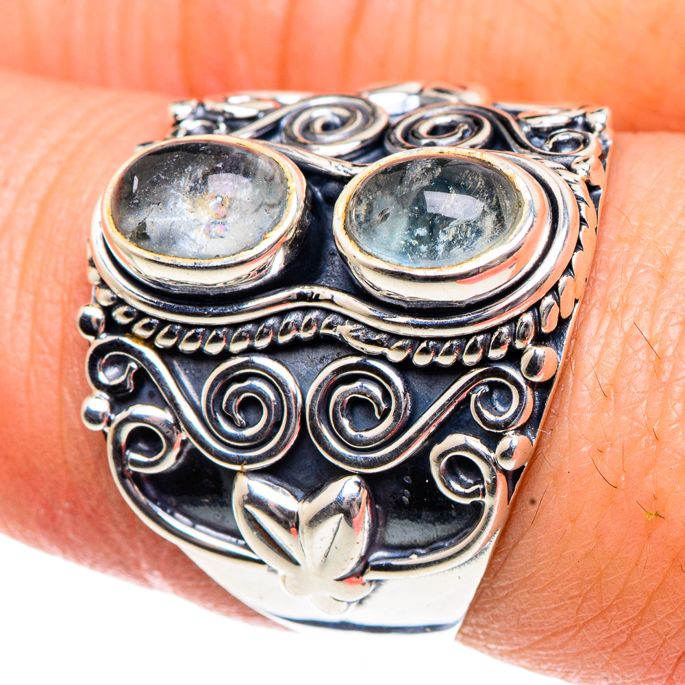 Sterling silver ring featuring two oval light blue stones with swirling bezel design