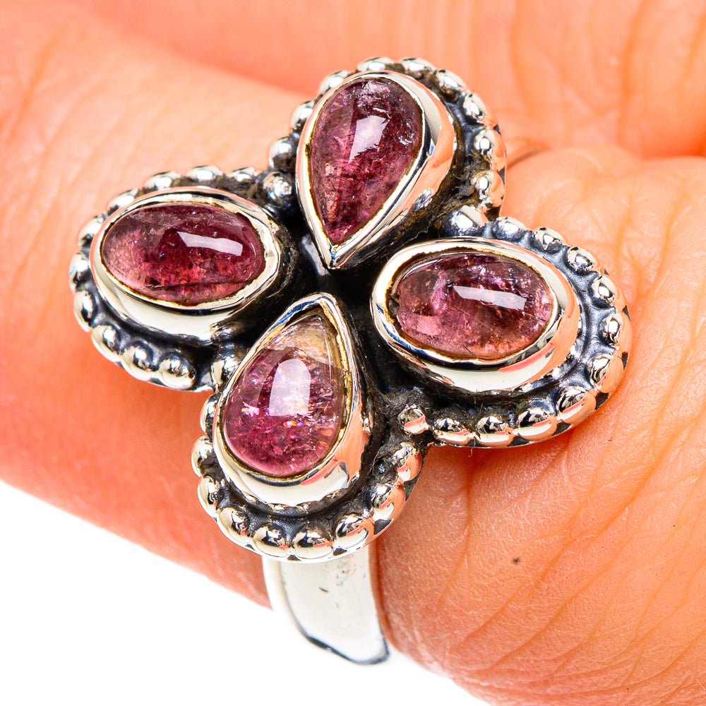 Pink tourmaline ring on hand with four oval stones in silver beaded settings
