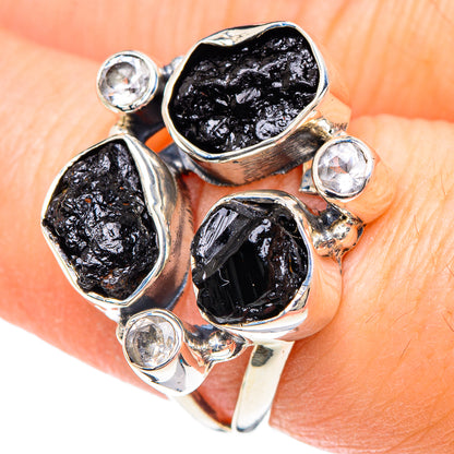 Sterling silver ring with four round clear stones and three rough black facets on top