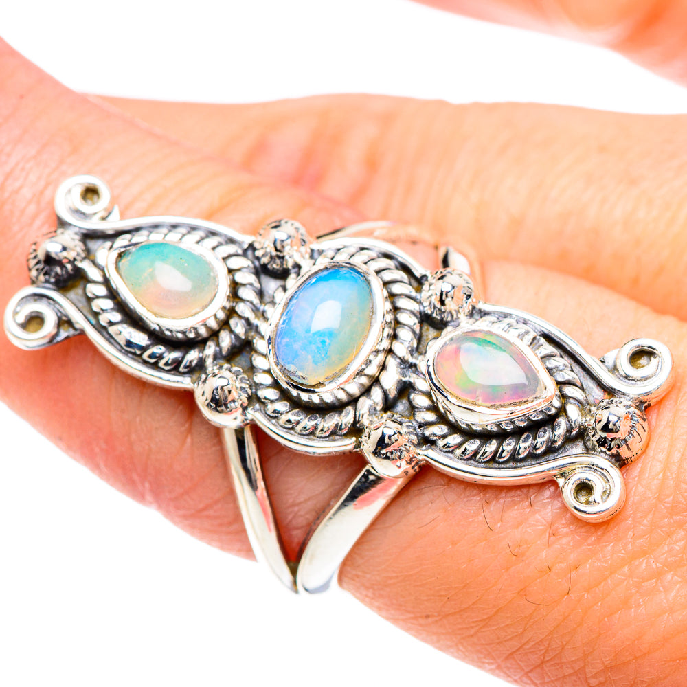Sterling silver opal ring with three oval iridescent stones on ornate split shank