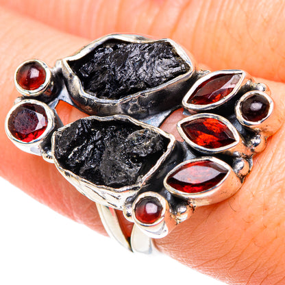 Close-up: sterling silver ring with rough black tourmaline and red garnet cabochons