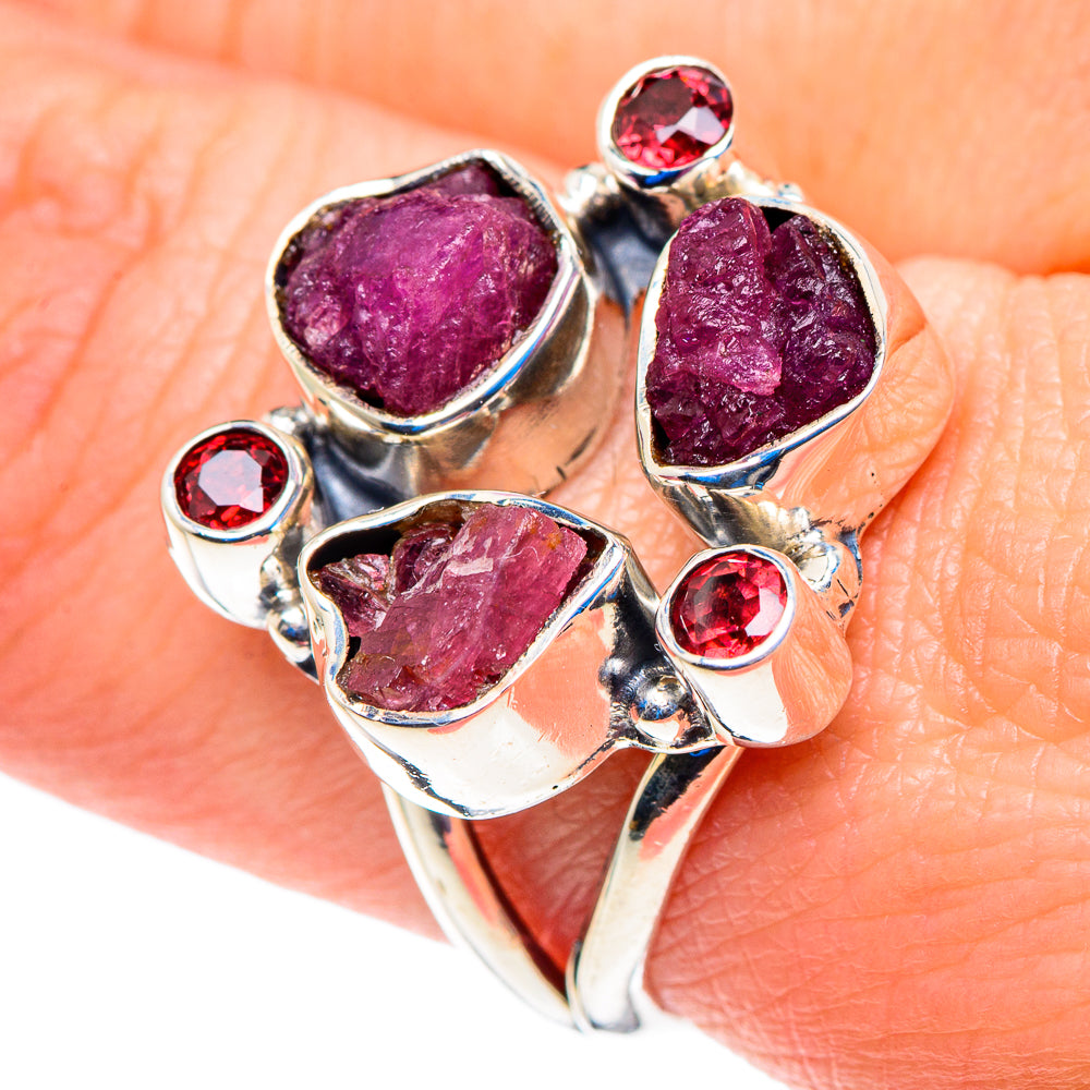 Sterling silver ring with three rough pink stones and four red round gemstones