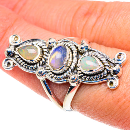 Opal-stone statement ring in sterling silver on finger, three pear-cut designs