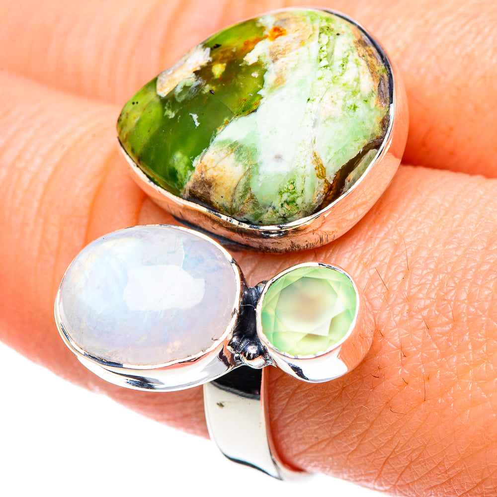 Adjustable sterling silver ring with oval green stone and two round opal accents