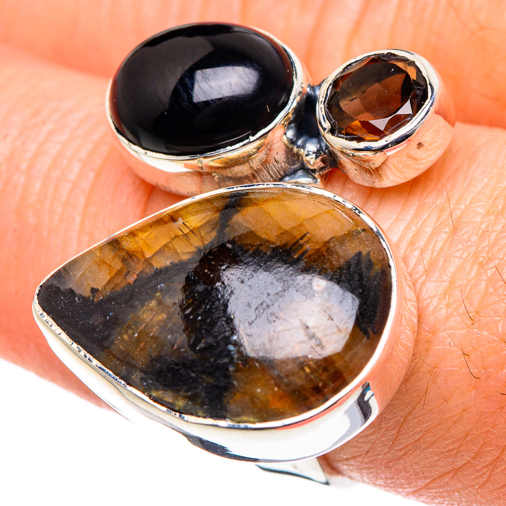 Sterling silver ring with large oval amber stone and dark black oval accents, adjustable