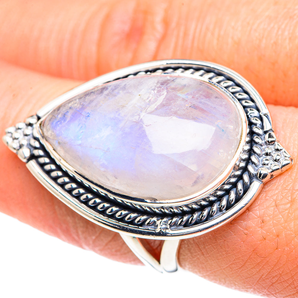 Silver teardrop moonstone ring with rainbow iridescence, ornate border setting