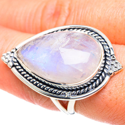 Silver teardrop moonstone ring with rainbow iridescence, ornate border setting