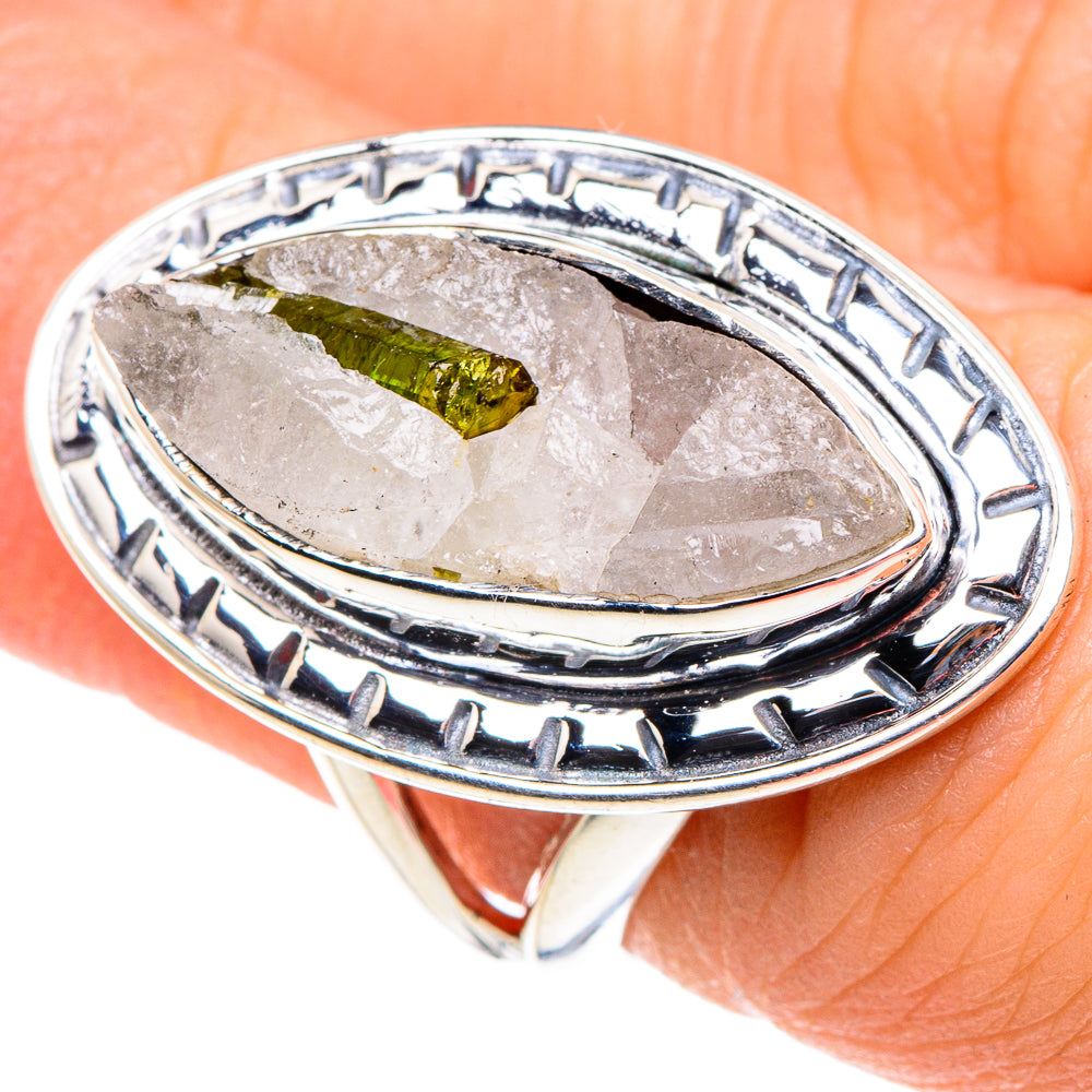 Sterling silver oval ring with green tourmaline in quartz, worn finger close-up