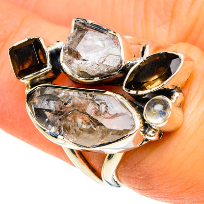 Sterling silver gemstone ring with large faceted clear stone, smoky accents, iridescent orb