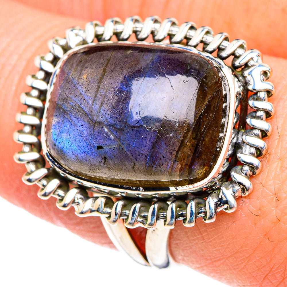 Sterling silver oval labradorite ring with blue-purple glow, halo bezel setting