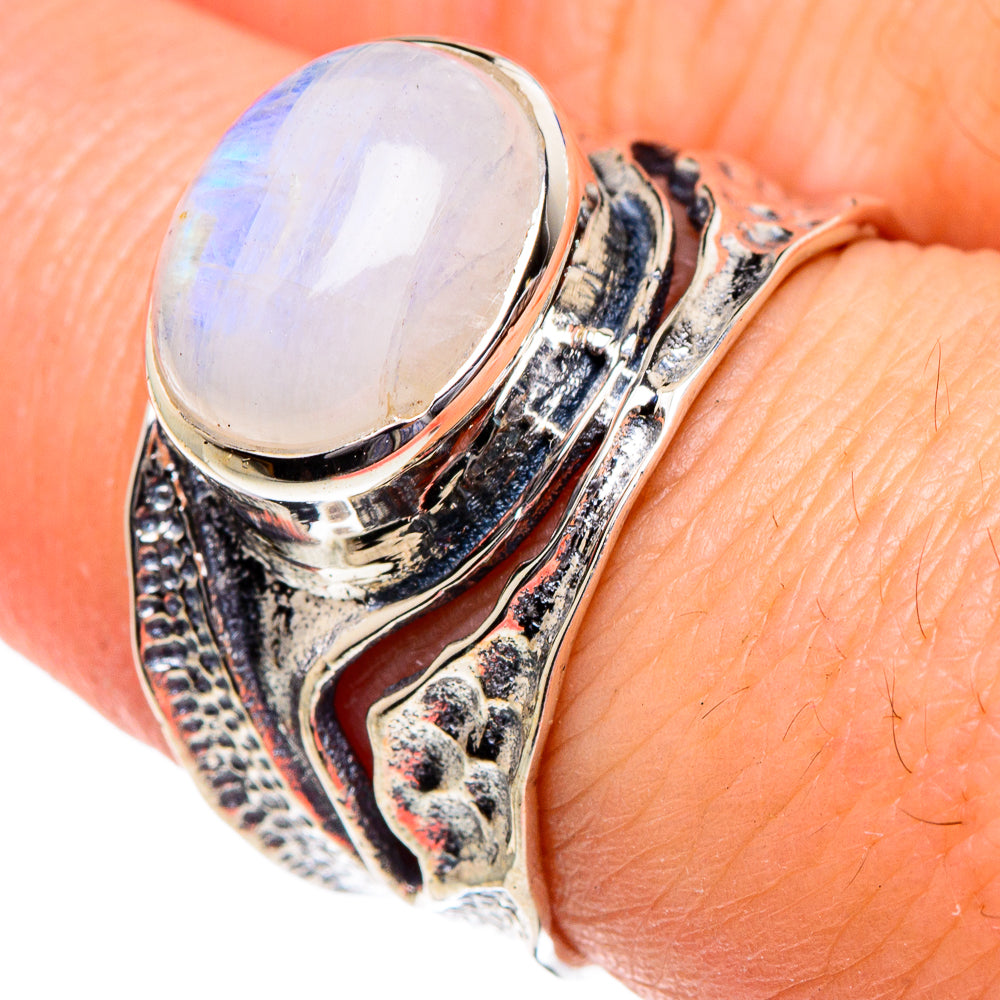 Oval moonstone set in an ornate 925 sterling silver ring, close-up on band