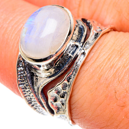 Oval moonstone set in an ornate 925 sterling silver ring, close-up on band
