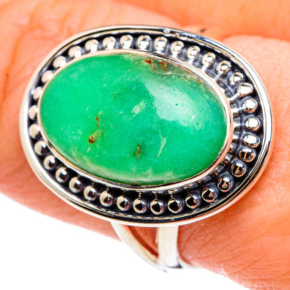 Oval green gemstone ring in 925 sterling silver with round bead border, on hand