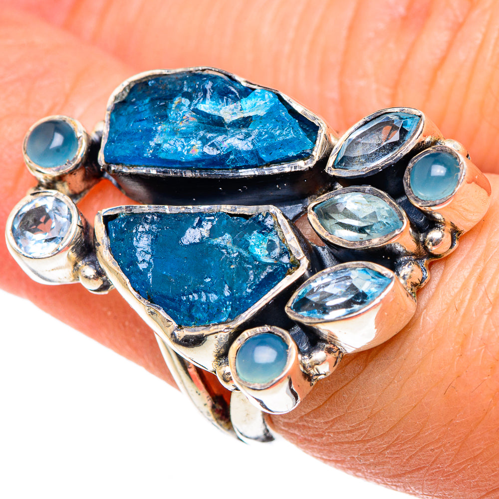 Sterling silver ring with rough blue gemstone center and bezel-set light blue stones