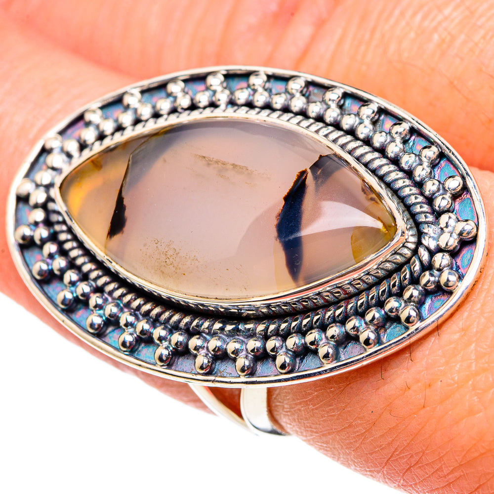 Sterling silver oval agate cabochon ring with bead border and blue accents