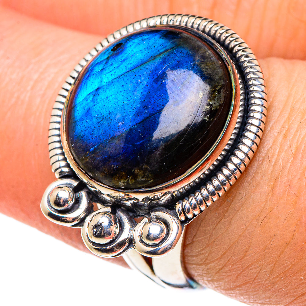Oval blue labradorite ring in 925 sterling silver with beaded edge and three round accents