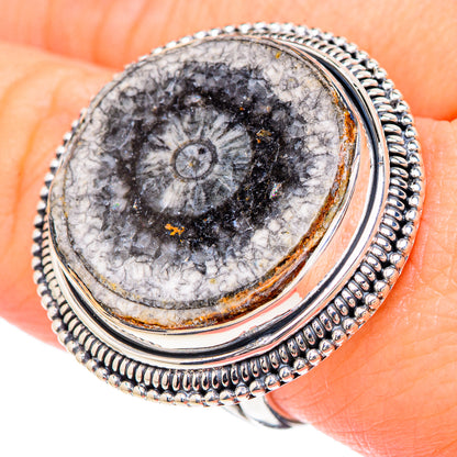 Oval goniatite fossil ring in 925 sterling silver, dark center with circular pattern, stack bands