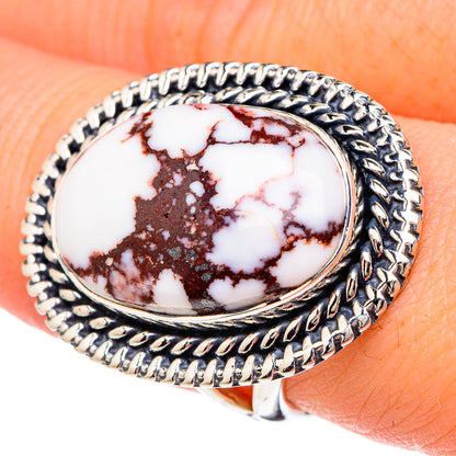 Wild horse jasper oval ring, detailed silver rope bezel; close-up on finger