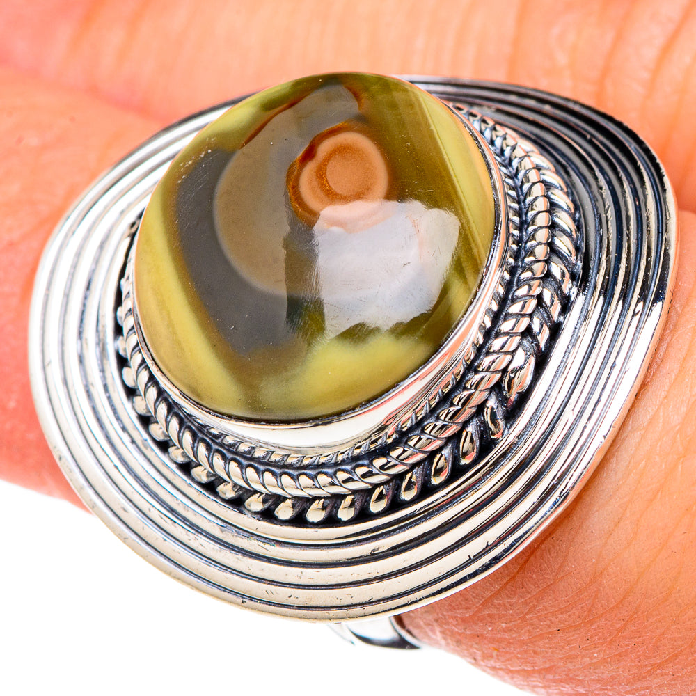 Sterling silver oval jasper cabochon ring with rope-style bezel, worn on finger