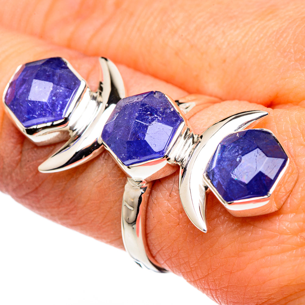 Sterling silver three-stone ring with blue-purple tanzanite-like octagon center stone