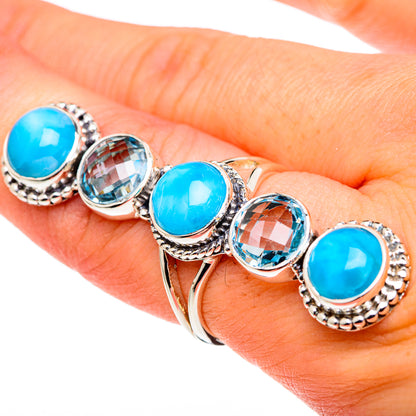 Sterling silver ring with five blue oval gemstones on a hand