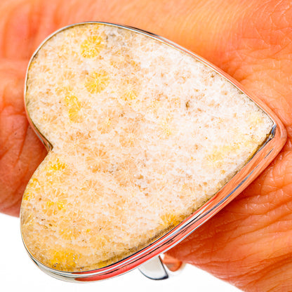 Heart-shaped fossil coral ring with silver-toned split band, worn on finger