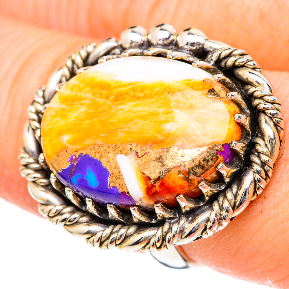 Oval orange cabochon ring with white patches, purple inlay, twisted rope silver bezel