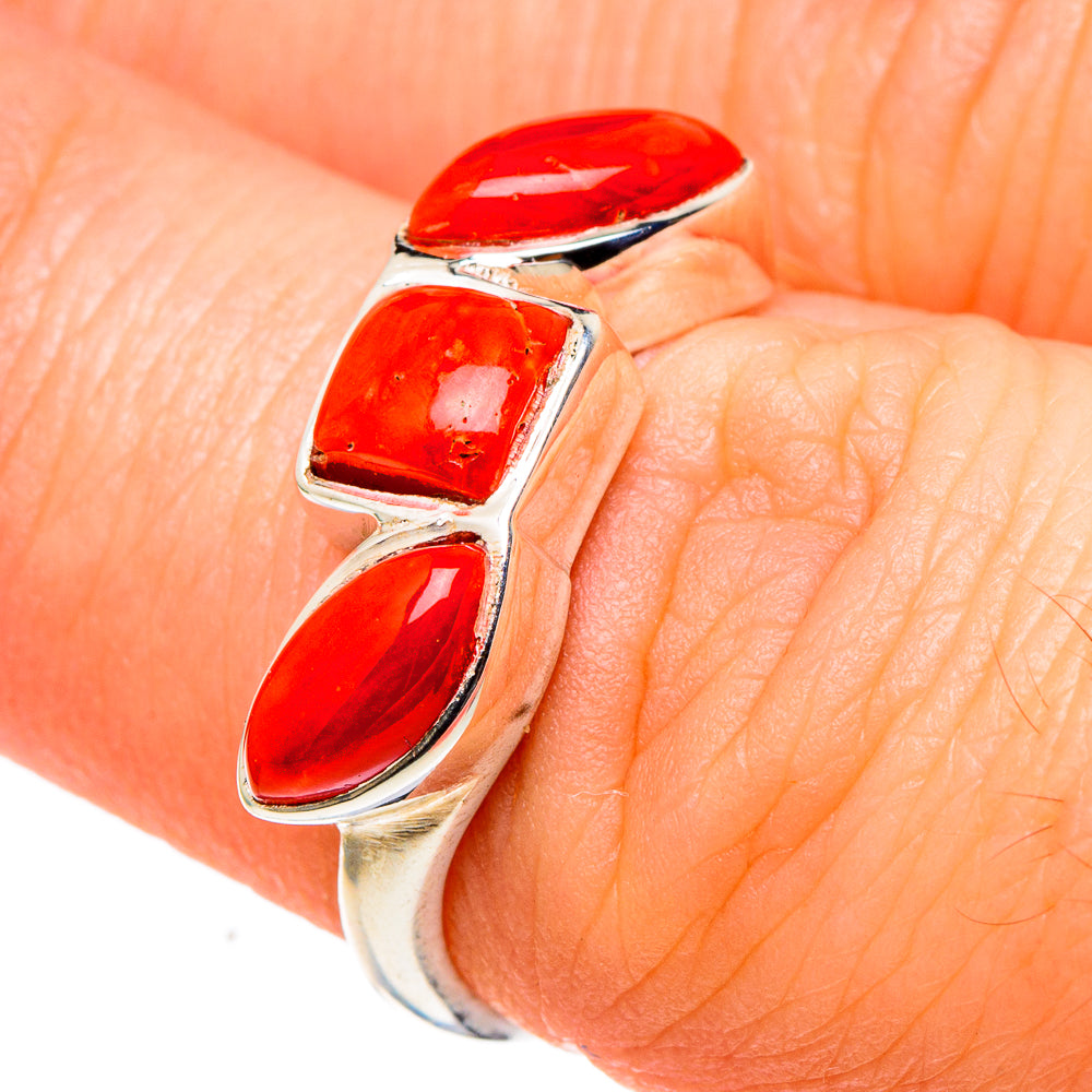 Sterling silver ring with red coral cabochons on finger, size 6.75