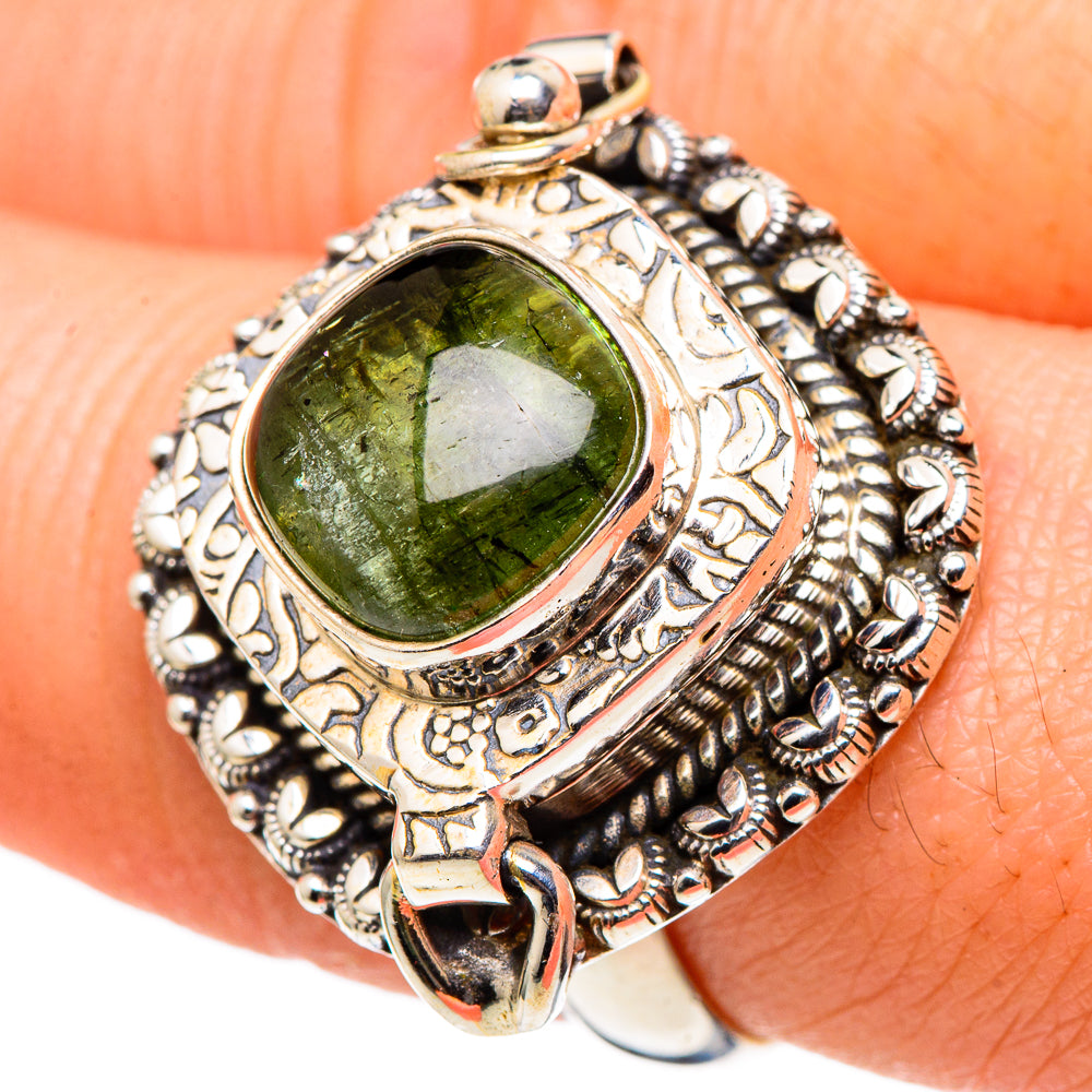 Antique silver ring with oval green tourmaline-style gemstone and engraved bezel.