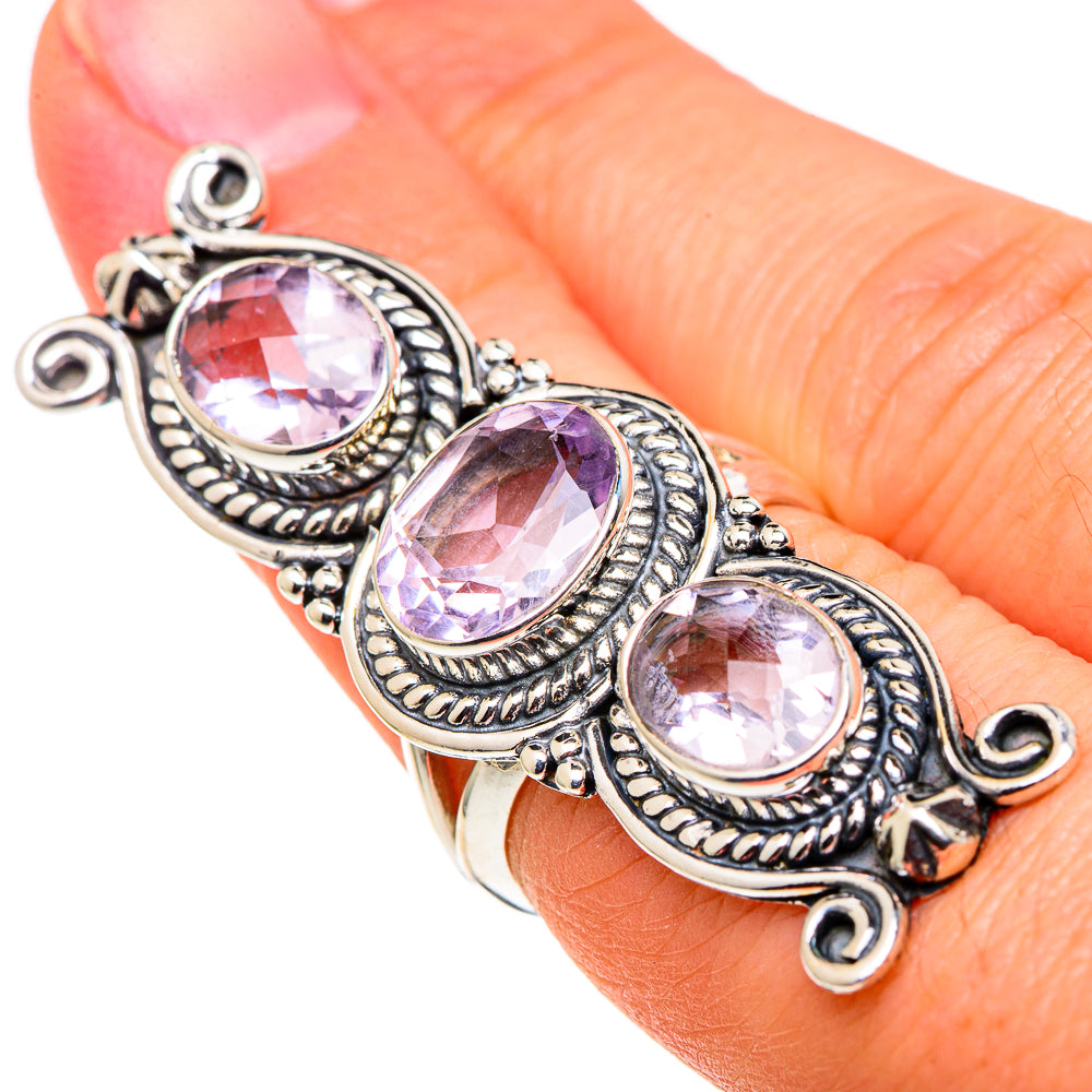 Sterling silver kunzite ring with three faceted oval stones on hand, ornate bezel