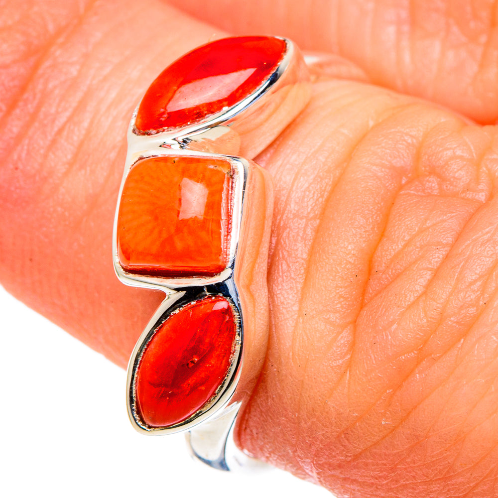 Close-up: sterling silver coral ring with three red oval stones on open band