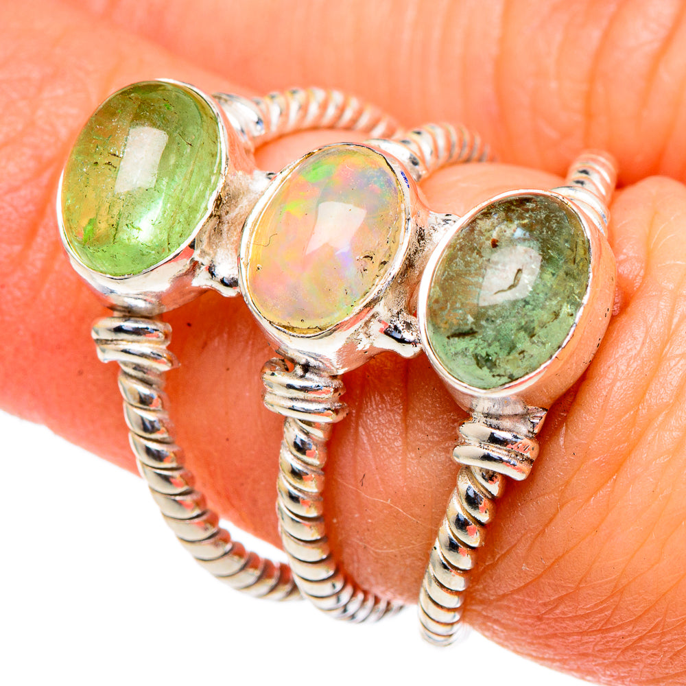 Sterling silver three-stone ring close-up: green prehnite side stones and iridescent opal center