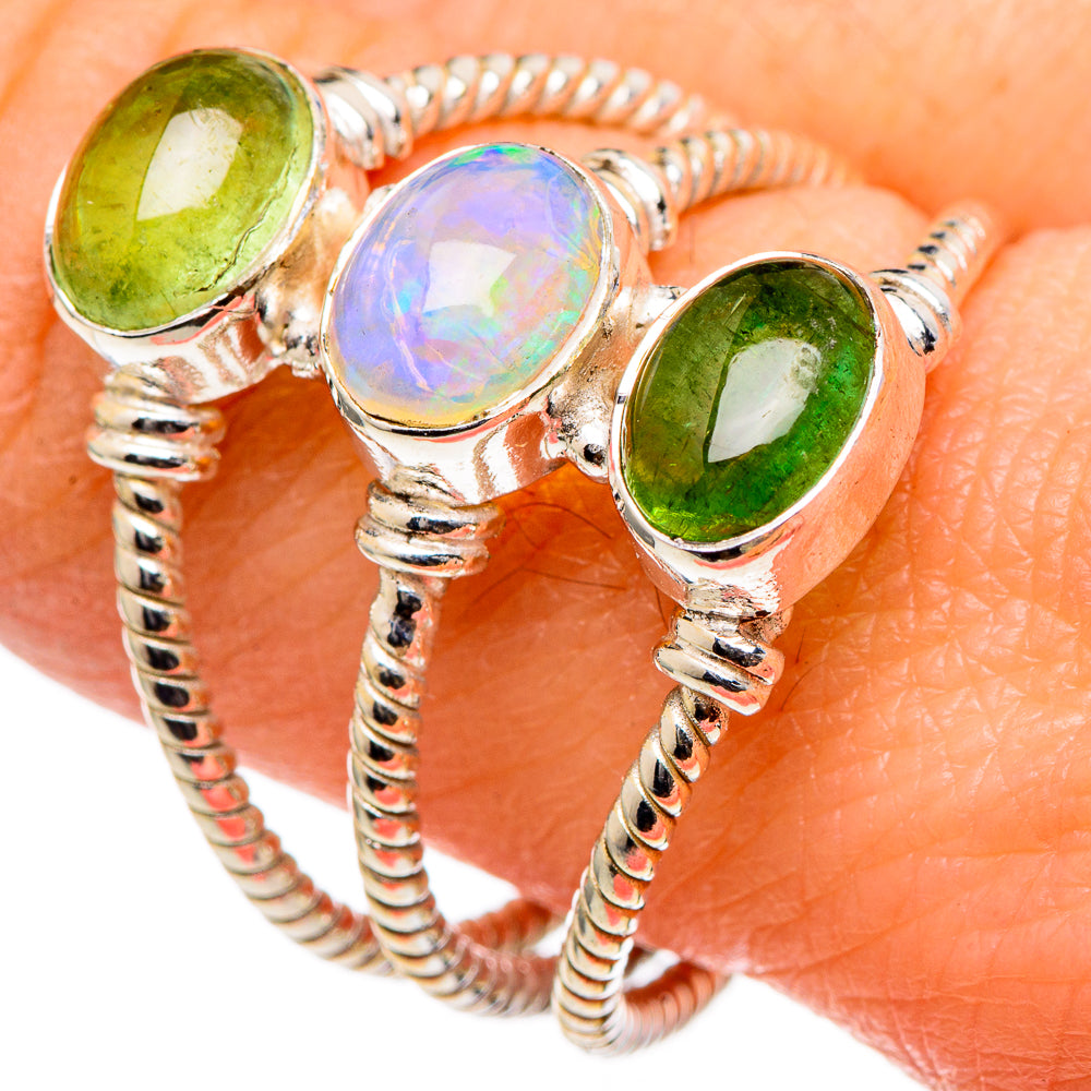 Three-stone sterling silver ring with green peridot, iridescent blue opal, rope shank