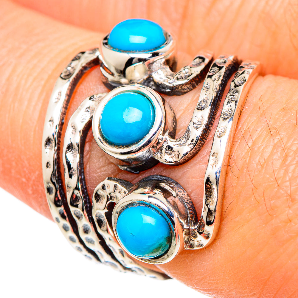 Turquoise oval cabochon 925 sterling silver ring with ornate swirl setting, close-up